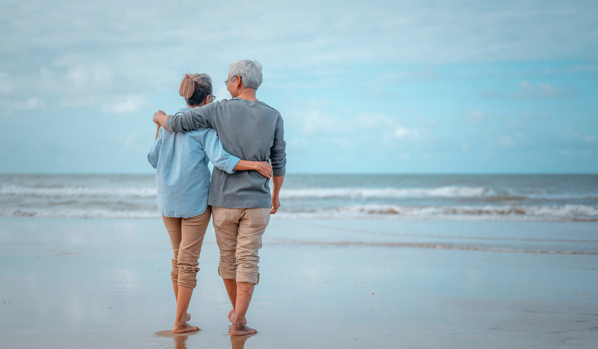 elder couple hugging and walking together at the beach chesapeake va