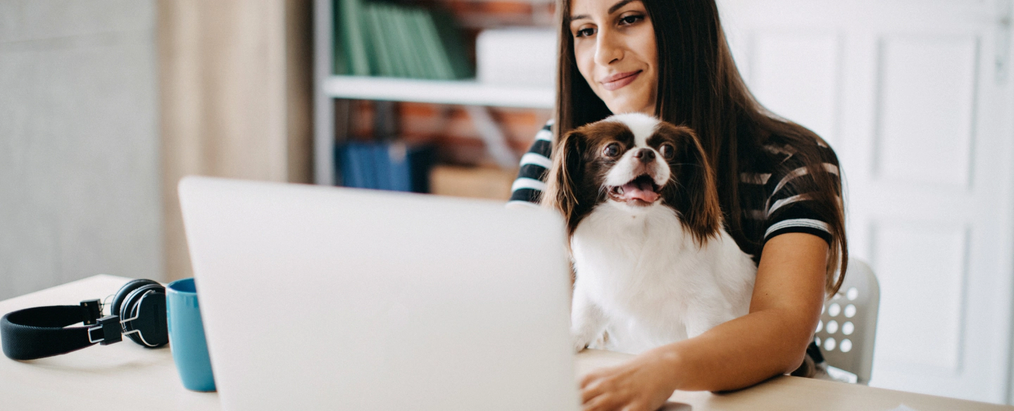financial agent working from home with her dog